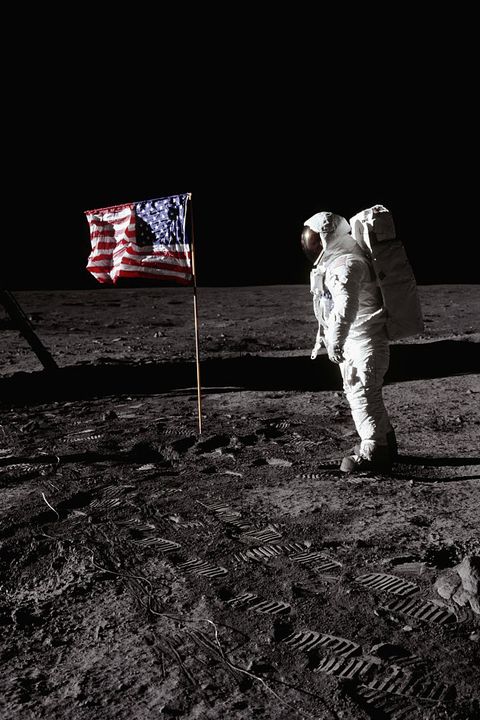 buzz aldrin-stands-beside-an-american-flag-at-tranquility